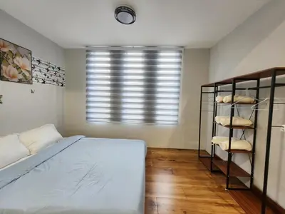 a bedroom with a bed and a window at Ipoh town7br5bath 25 pax pool table mahjong karaok in Ipoh