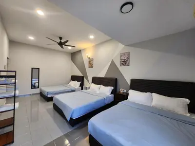 a bedroom with two beds and a ceiling fan at Ipoh town7br5bath 25 pax pool table mahjong karaok in Ipoh