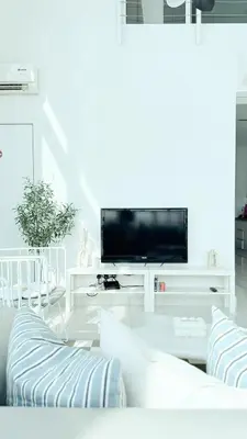 a white living room with a flat screen tv at Maritime Suite Full Seaview Georgetown in George Town