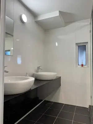 a white bathroom with a sink and a mirror at Maritime Suite Full Seaview Georgetown in George Town