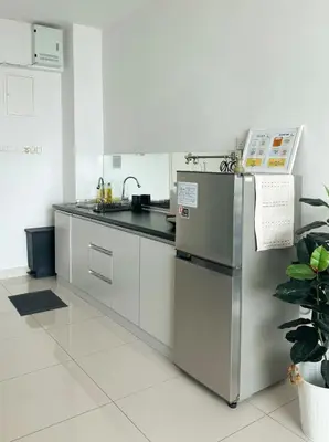 a kitchen with a stainless steel refrigerator at Maritime Suite Full Seaview Georgetown in George Town