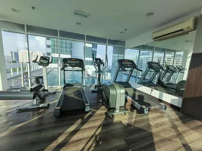 a gym with several treadmills in a building at Maritime Suite Full Seaview Georgetown in George Town