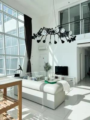 a living room with a white couch and a chandelier at Maritime Suite Full Seaview Georgetown in George Town