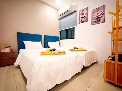 a bedroom with a large white bed with a blue headboard at Ipoh Manhattan Waterpark Suite by City Home Empire MHB403 in Ipoh