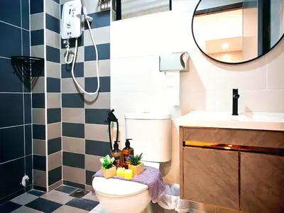 a bathroom with a toilet and a sink and a mirror at Ipoh Manhattan Waterpark Suite by City Home Empire MHB403 in Ipoh
