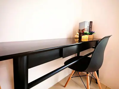 a black desk with a black chair in a room at Ipoh Manhattan Waterpark Suite by City Home Empire MHB403 in Ipoh