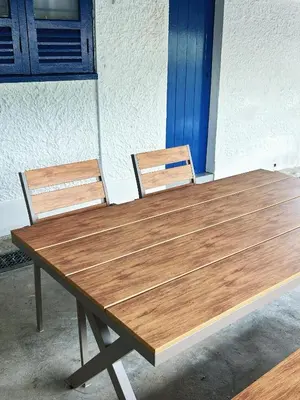 a wooden table with two chairs sitting next to it at Santorini Canning Garden in Ipoh