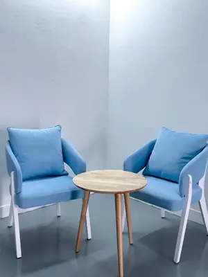 two blue chairs and a table in a room at Santorini Canning Garden in Ipoh
