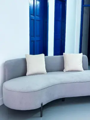a blue couch with two white pillows on it at Santorini Canning Garden in Ipoh