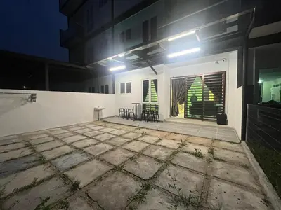 a patio with chairs and a christmas tree in a building at Mossy Green Golfcourse Homestay in Tanah Rata