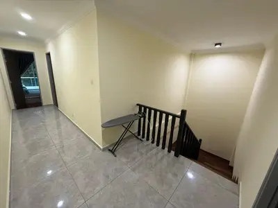 a hallway with a staircase and a bench in a room at Mossy Green Golfcourse Homestay in Tanah Rata