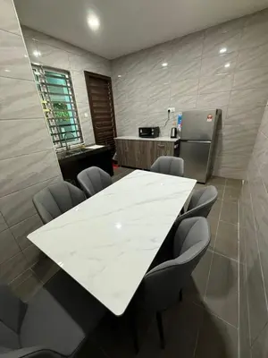 a conference room with a white table and chairs at Mossy Green Golfcourse Homestay in Tanah Rata