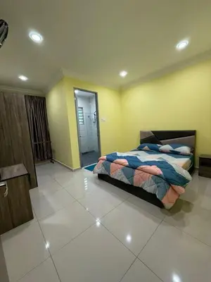 a bedroom with a bed and a tiled floor at Mossy Green Golfcourse Homestay in Tanah Rata