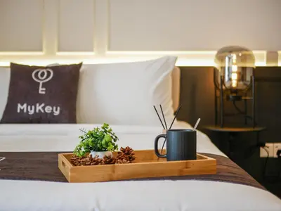 a tray with a coffee mug and plants on a bed at 22 Macalisterz by MyKey in George Town