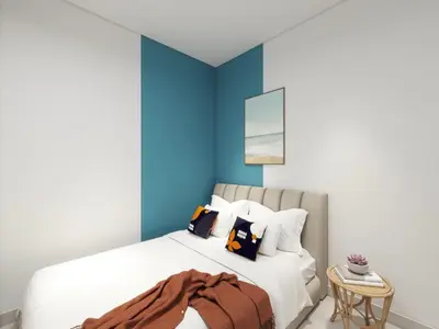 a bedroom with a white bed with blue walls at 22 Macalisterz by MyKey in George Town