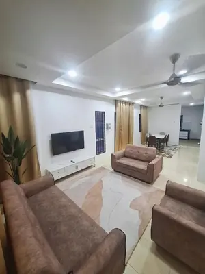 a living room with two couches and a flat screen tv at Zehra Villa Seri Iskandar with Private Pool in Seri Iskandar