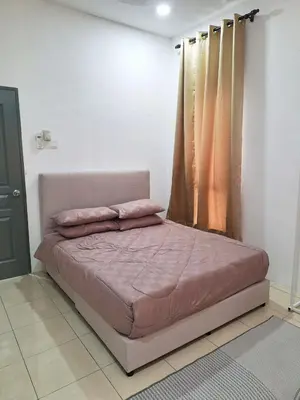 a bedroom with a bed with pink sheets and a window at Zehra Villa Seri Iskandar with Private Pool in Seri Iskandar