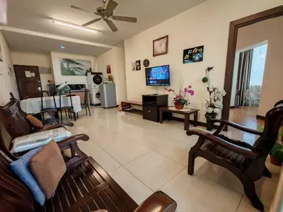 a living room with a couch and a tv at Tower Regency Hotel & Apartments in Ipoh