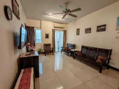 a living room with a couch and a tv at Tower Regency Hotel & Apartments in Ipoh