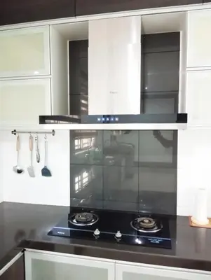 a kitchen with a black stove and white cabinets at HD Jaya Shine Homestay in Sungai Petani