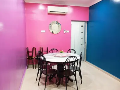 a dining room with pink and blue walls and a table at HD Jaya Shine Homestay in Sungai Petani