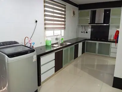 a kitchen with black and white cabinets and a sink at HD Jaya Shine Homestay in Sungai Petani