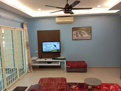 a living room with a ceiling fan and a flat screen tv at HD Jaya Shine Homestay in Sungai Petani