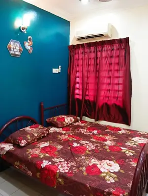 a bedroom with a bed with a red curtain at HD Jaya Shine Homestay in Sungai Petani
