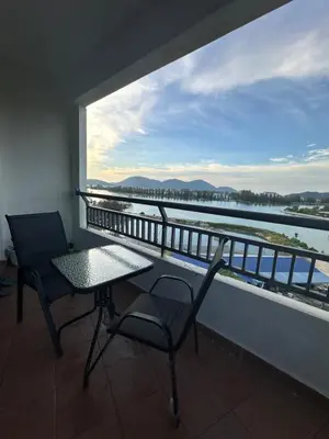 a balcony with a table and chairs and a view of the water at Homestay in Marina Heights with beach view in Lumut