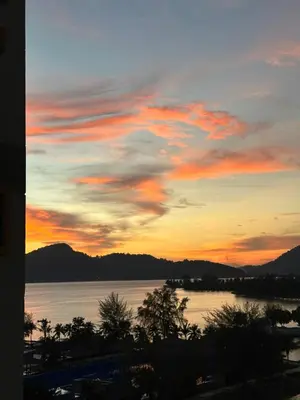 a sunset over a body of water with at Homestay in Marina Heights with beach view in Lumut