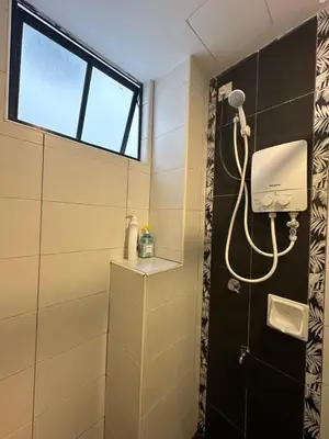 a shower in a bathroom with a window at Homestay in Marina Heights with beach view in Lumut