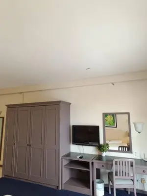 a room with a desk with a computer and a mirror at Sky beach resort in Tanjung Bungah