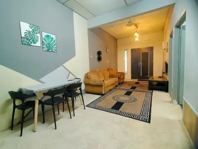 a living room with a piano and a couch at RZ HOMESTAY With WiFi in Sungai Siput