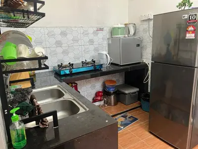 a kitchen with a sink and a refrigerator at RZ HOMESTAY With WiFi in Sungai Siput