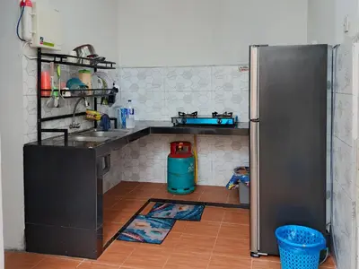 a kitchen with a sink and a refrigerator at RZ HOMESTAY With WiFi in Sungai Siput
