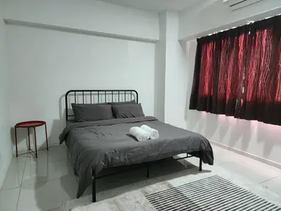 a bedroom with a bed with two towels on it at Family Haven at Paragon in Gua Sai