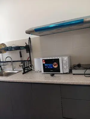 a microwave sitting on a counter in a kitchen at Ereens homestay Cameron highland in Brinchang