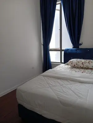 a bedroom with a bed and a window with blue curtains at Ereens homestay Cameron highland in Brinchang