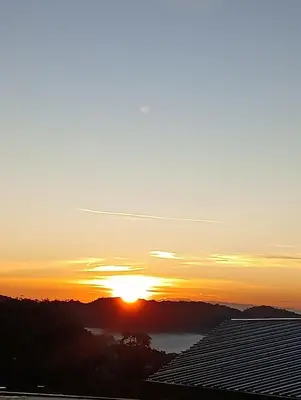 a sunset over a city with solar panels at Ereens homestay Cameron highland in Brinchang