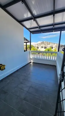 an empty patio with a white wall and a balcony at LiveLikeYourHome, RajaUda Butterworth