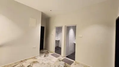 an empty room with a hallway with marble floors at LiveLikeYourHome, RajaUda Butterworth