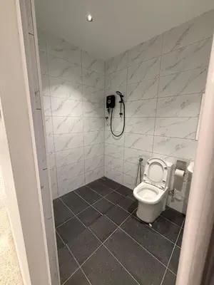 a small bathroom with a toilet and a shower at LiveLikeYourHome, RajaUda Butterworth
