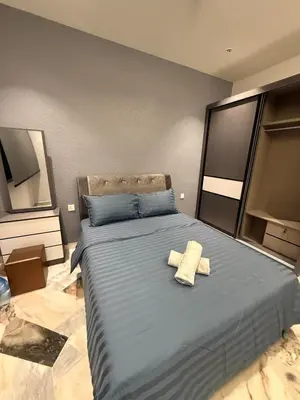 a bedroom with a large bed with two towels on it at LiveLikeYourHome, RajaUda Butterworth