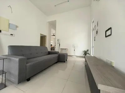 a living room with a couch and a table at Padang Serai Wangi Homestay 55 in Gua Sai