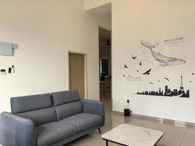 a living room with a couch and birds on the wall at Padang Serai Wangi Homestay 63 in Padang Serai