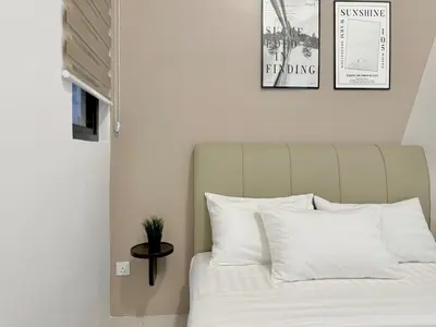 a bedroom with a bed with white pillows at Urban Suites #Tiny walnut 2BR1bath suite #Infinity Pool #4pax #2 Queens #Quality well maintained #Private host in Jelutong