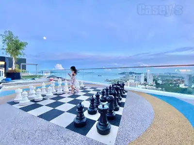 a little girl playing chess on a chess board at Urban Suites #Tiny walnut 2BR1bath suite #Infinity Pool #4pax #2 Queens #Quality well maintained #Private host in Jelutong