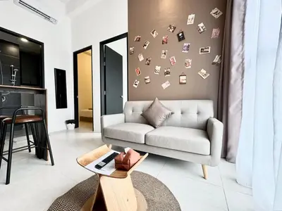 a living room with a couch and a table at Urban Suites #Tiny walnut 2BR1bath suite #Infinity Pool #4pax #2 Queens #Quality well maintained #Private host in Jelutong