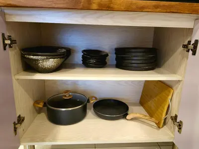 a shelf with pots and pans in a cabinet at #MyHillsideHideaway at Quintet, Cameron Highlands in Tanah Rata