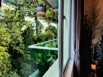a window with potted plants on a window sill at #MyHillsideHideaway at Quintet, Cameron Highlands in Tanah Rata